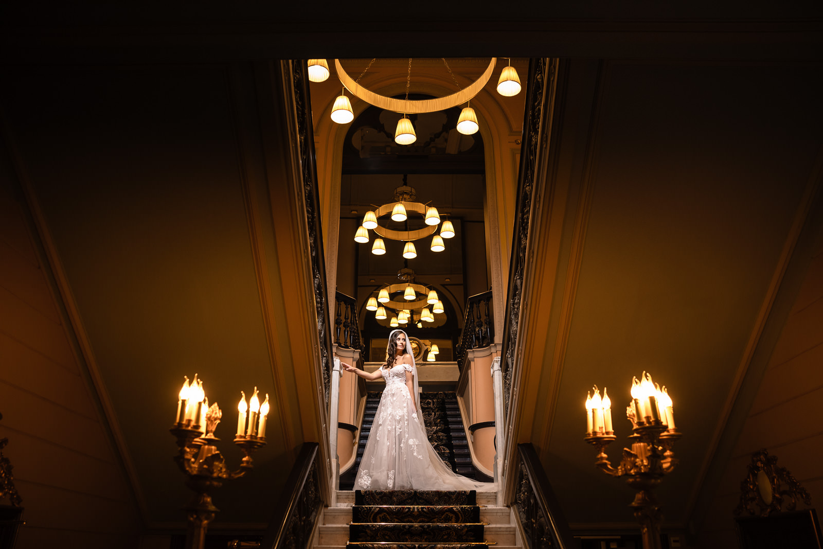 Bride on hatel des indes staircase coming down for her Intimate Beach Wedding Photographer