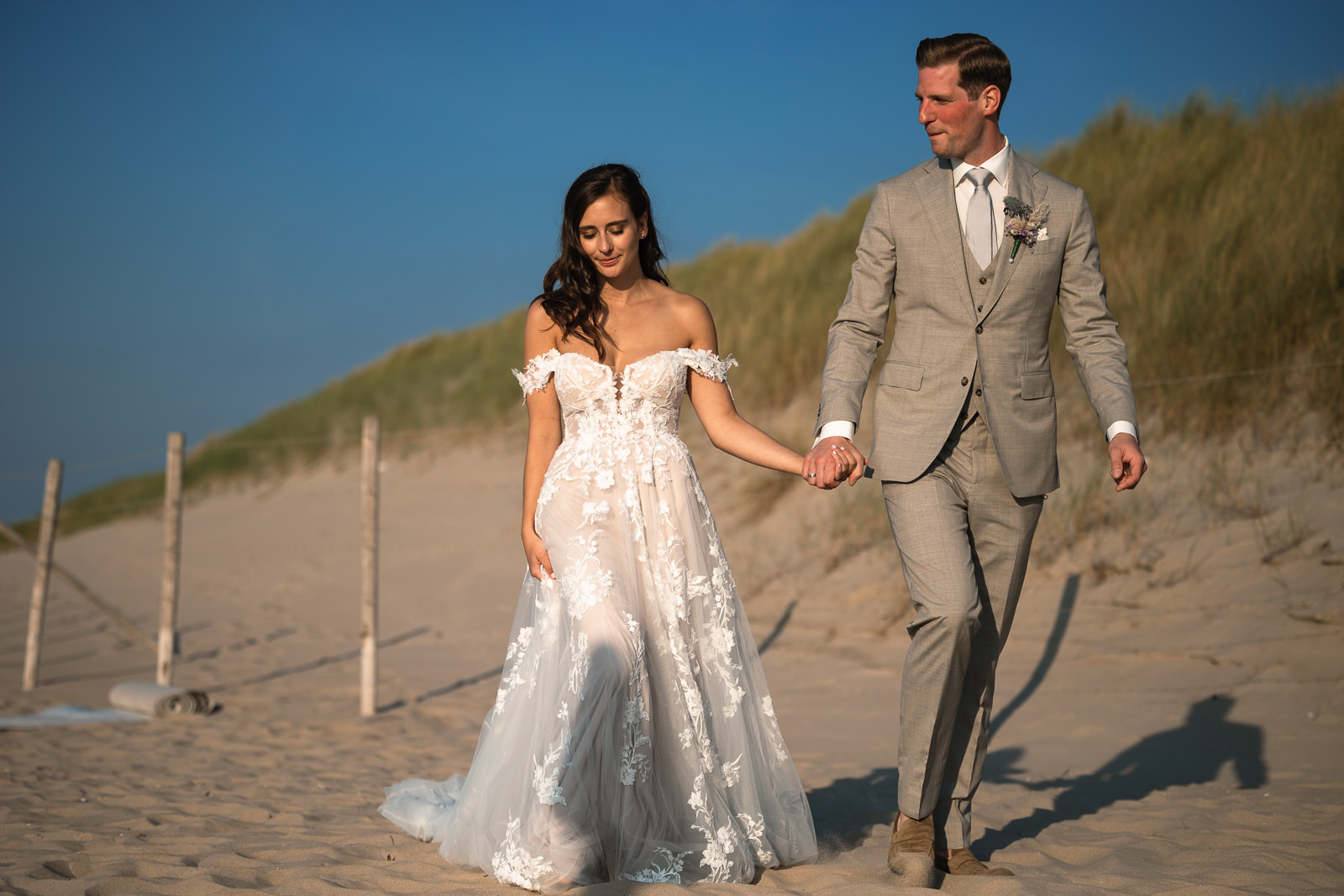 Bride and groom walk away from Intimate beach wedding