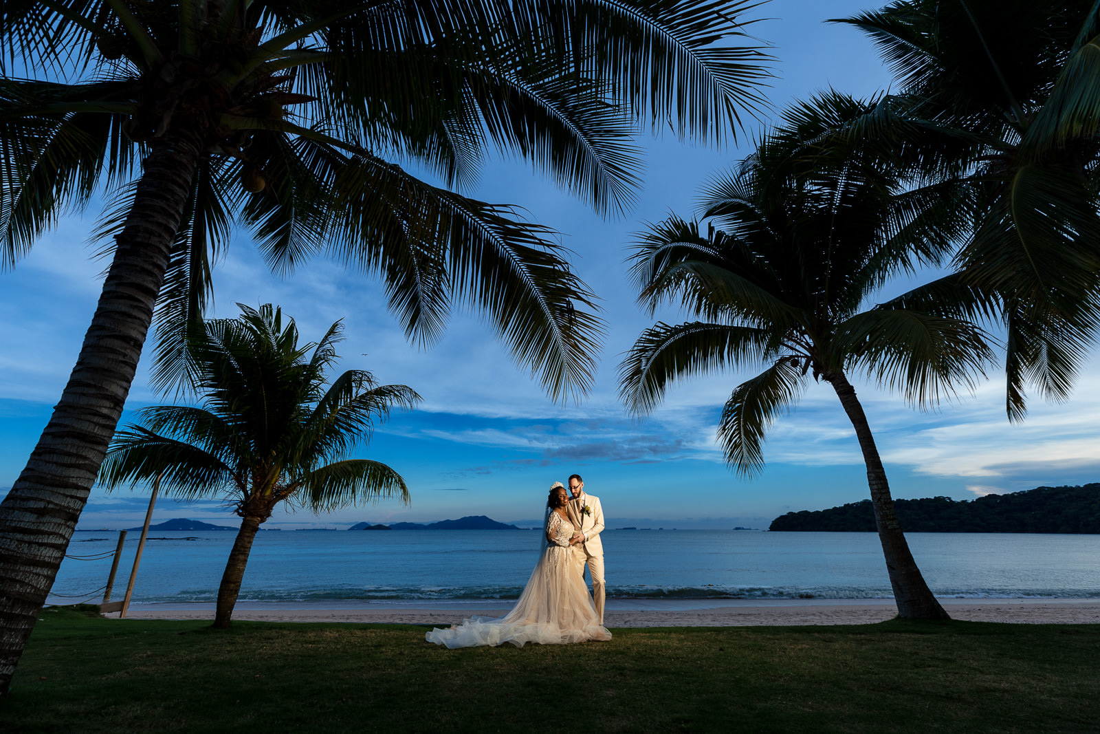 Destination wedding photographer Panama bride and groom beach sunset with palmtrees