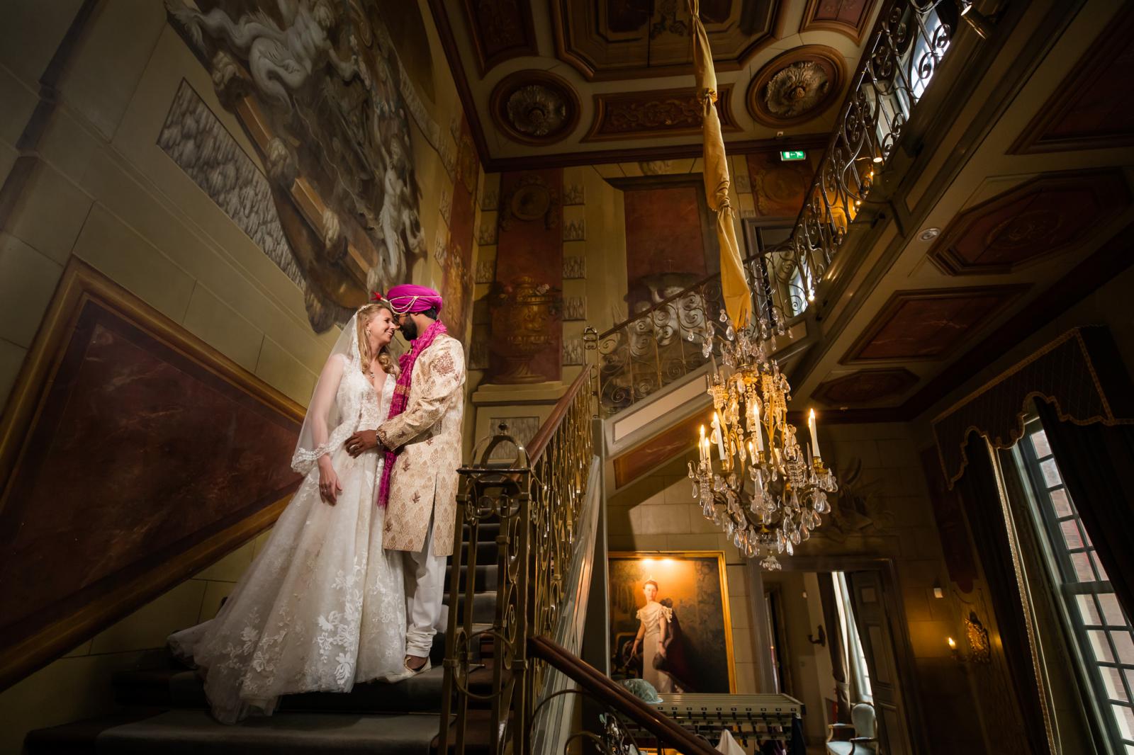 Bruidspaar binnen op trap Slot Zeist