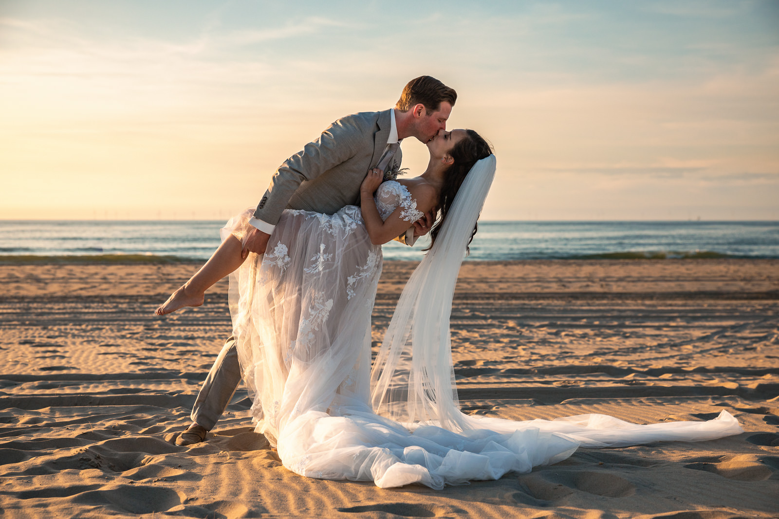 Bride and groom kissing on the beach