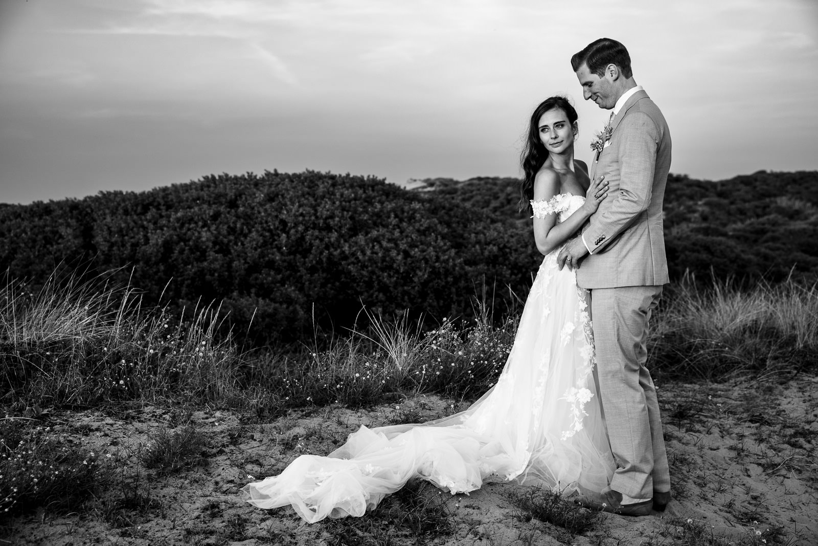 Bride and groom looking at the sunset