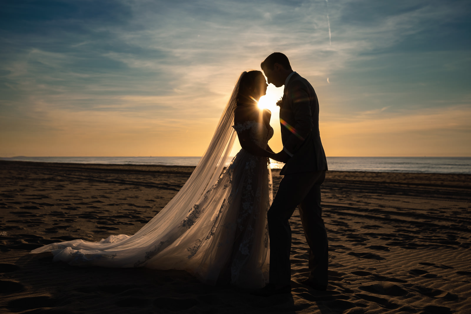 Bride and goorm sunset silhouette Intimate beach wedding