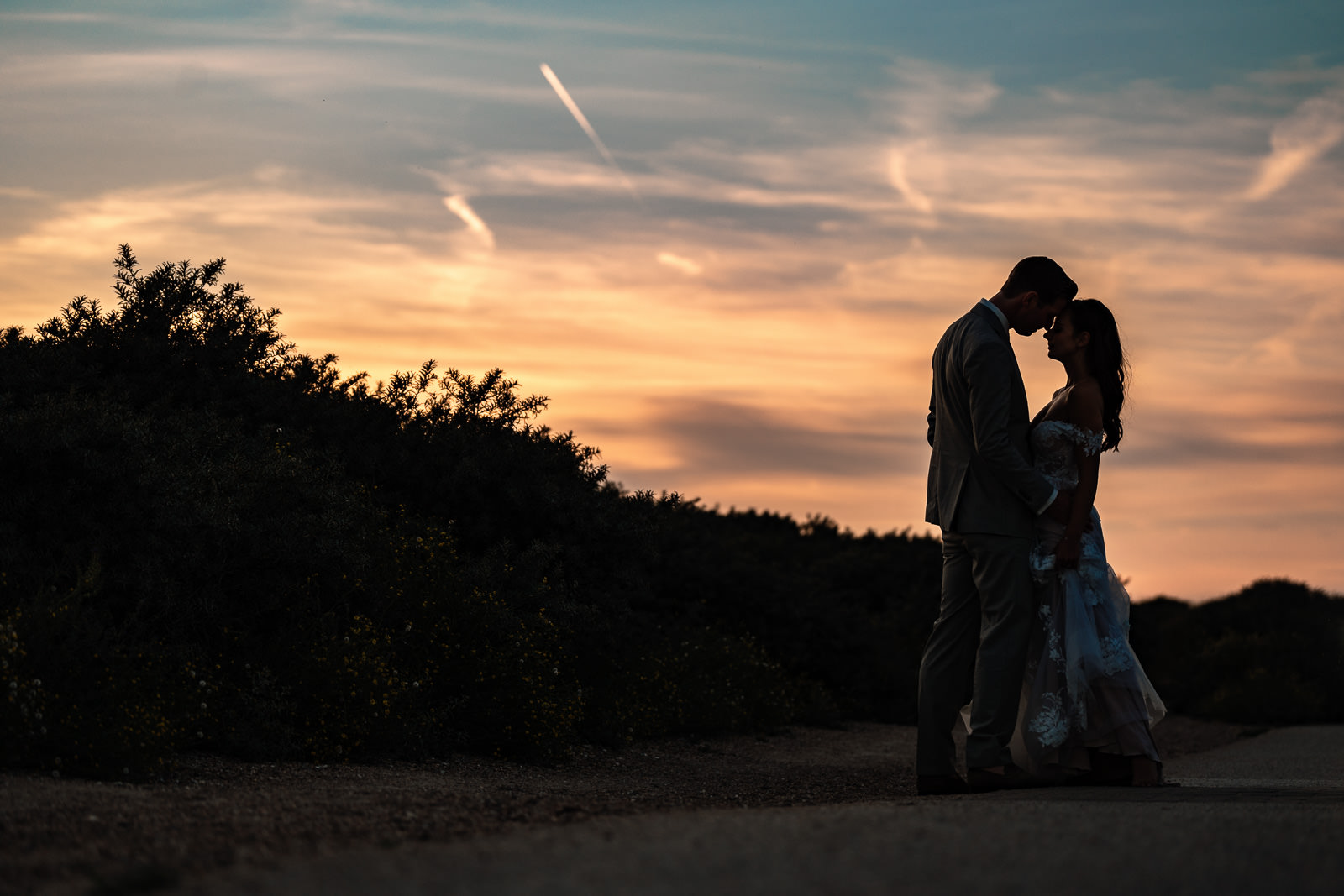 Sunset shoot in the dunes with bride and groom