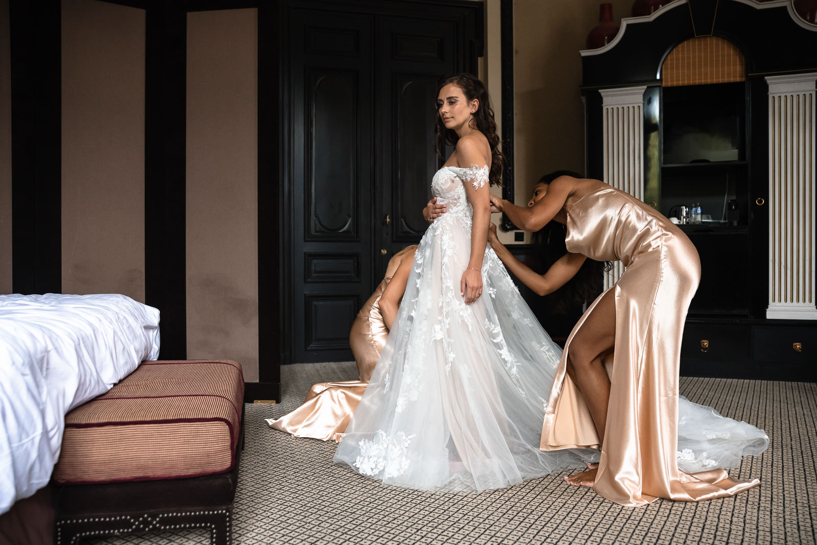 Bridesmaids help bride into wedding dress Intimate Beach Wedding Photographer