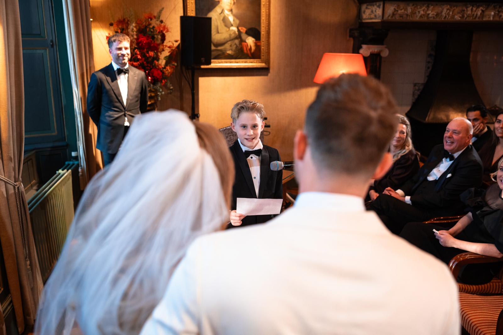 Zoon leest een emotionele speech voor aan het bruidspaar.