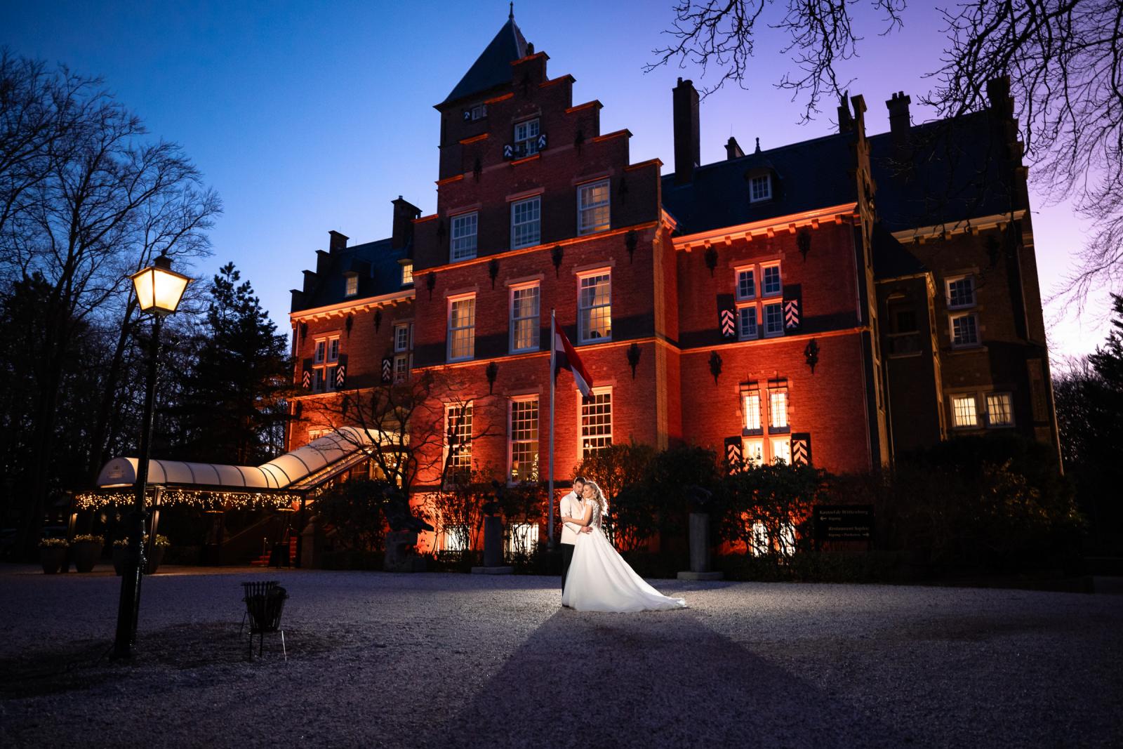 Fotoshoot buiten bij het kasteel tijdens het blauwe uur, ultieme kerstbruiloft setting.