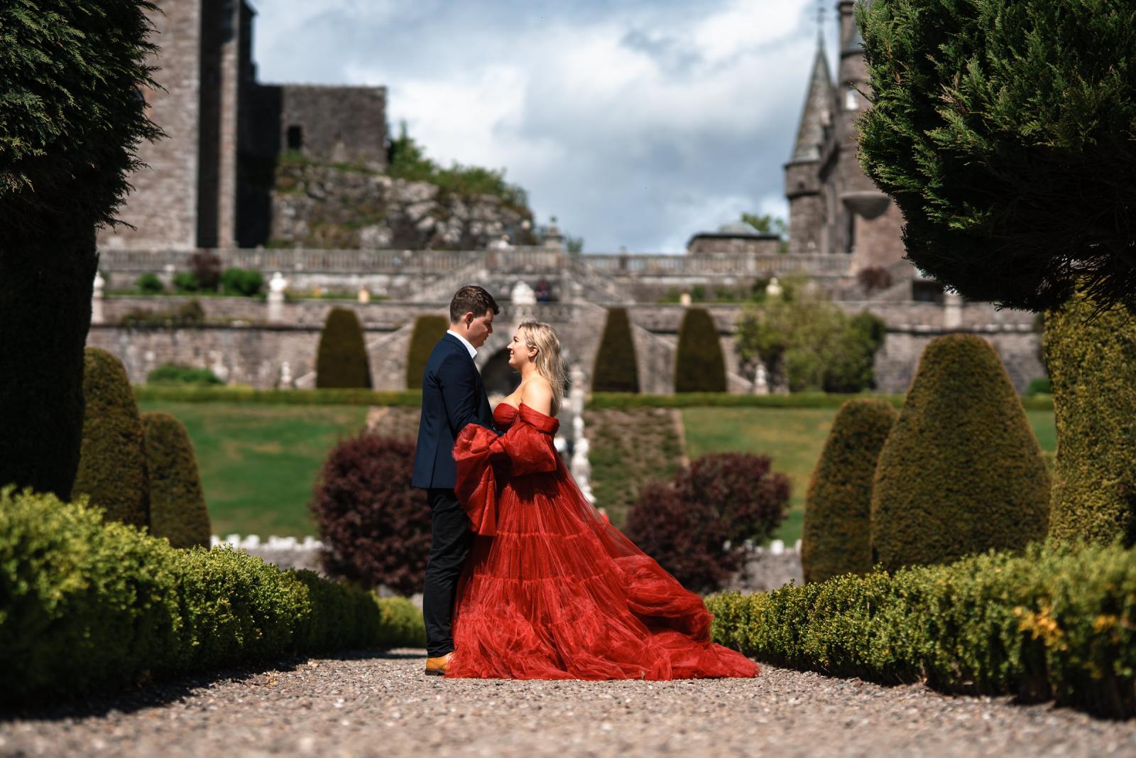 Intimate and elegant fine-art portrait of the couple on a gravel path with the Scottish castle gardens as a backdrop
