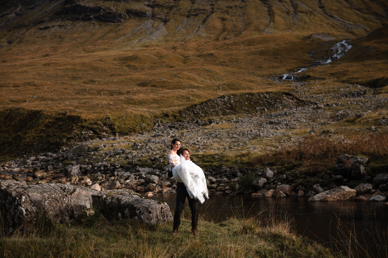 Highlands Wedding Photographer Scotland Groom picks up bride 