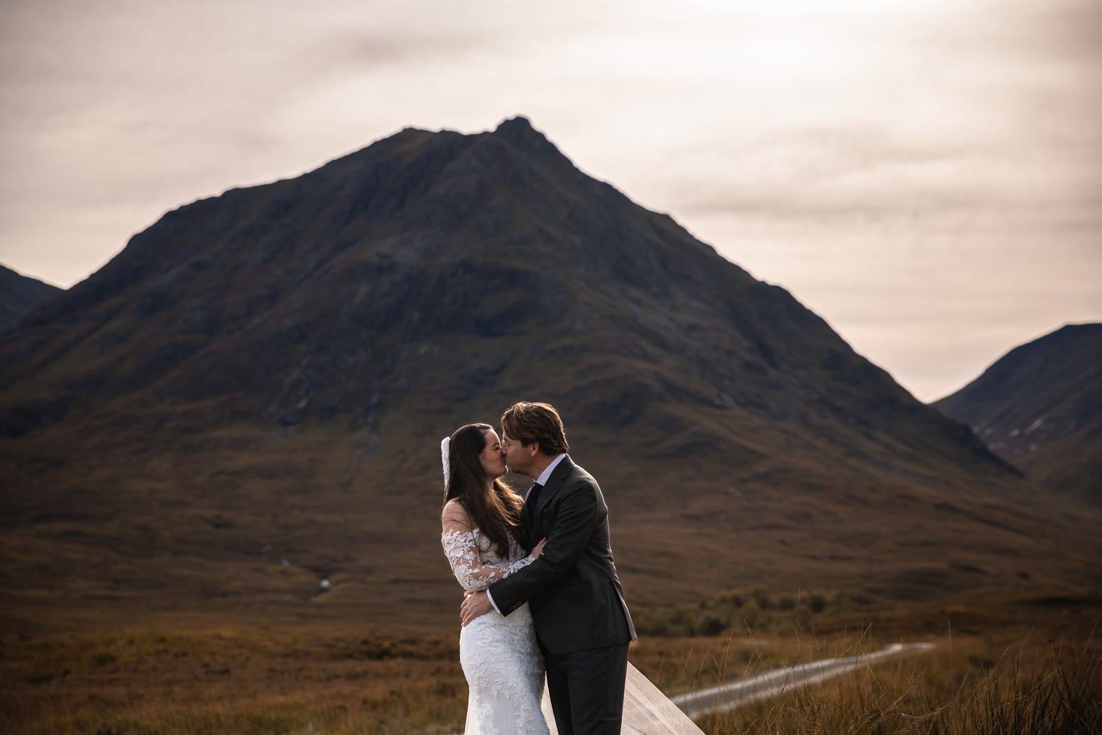 Wedding photographer Highlands Scotland Glencoe Mountain Couple kiss