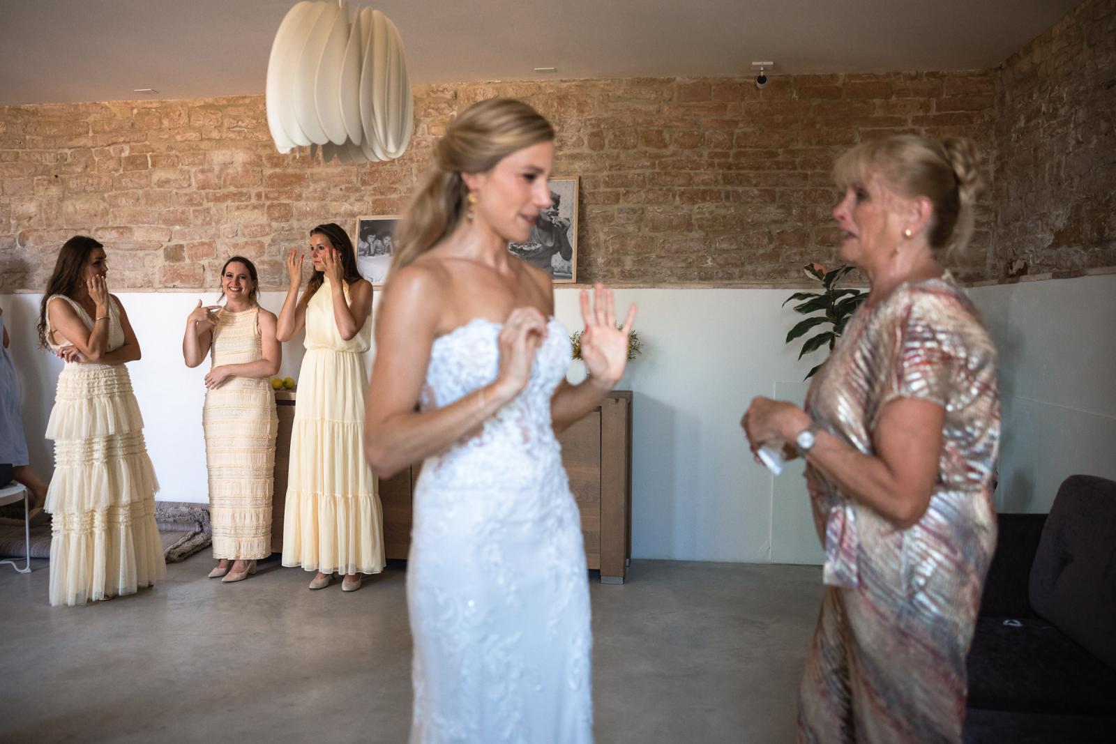 Bride Gemmy fanning herself in excitement while getting ready for her Italian destination wedding