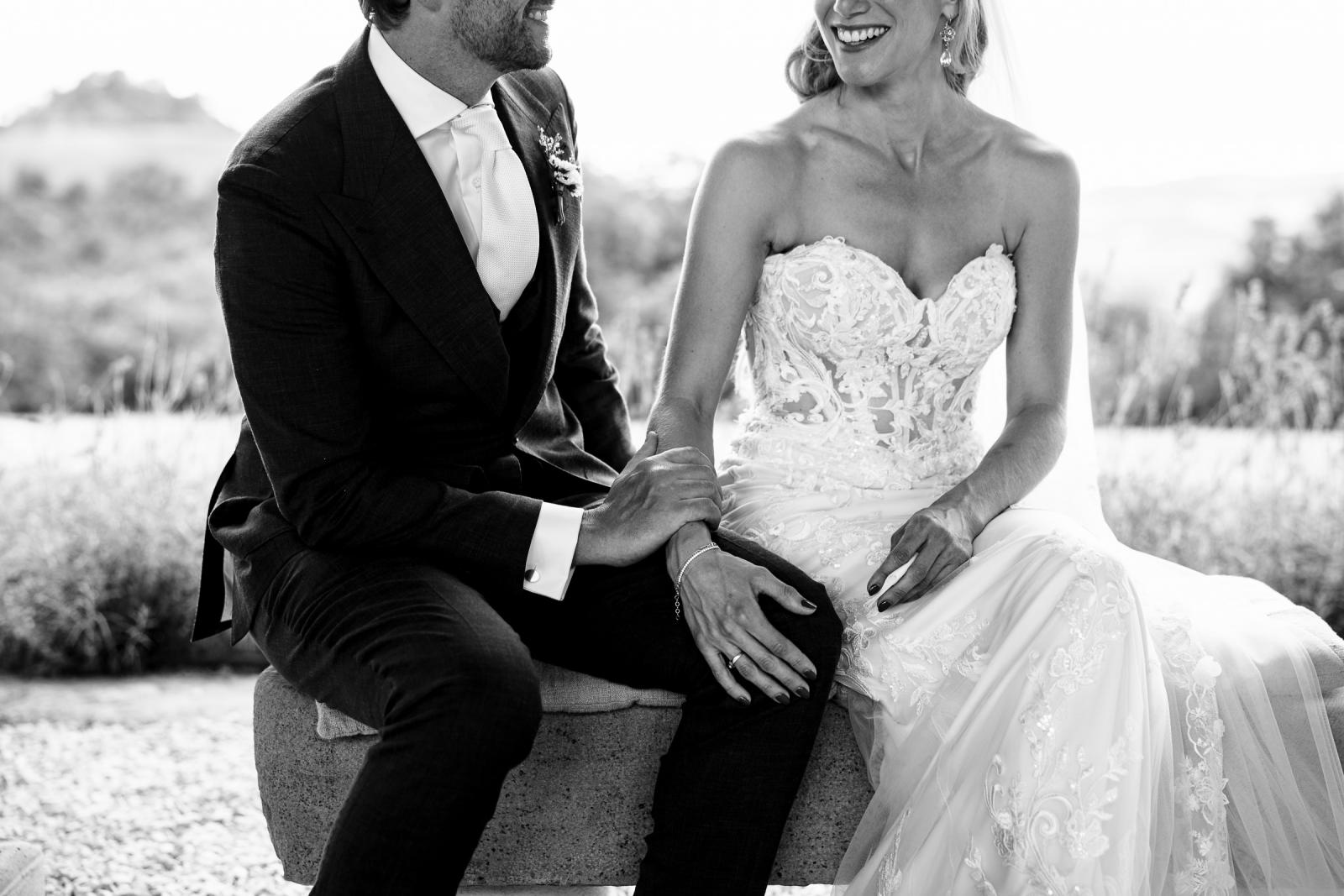 Black and white close up of groom Niels holding bride Gemmy hand during wedding ceremony