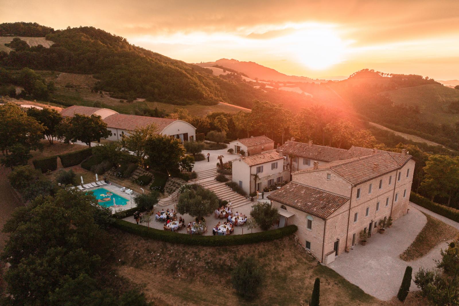 Sunset aerial view of entire Le Stonghe estate during outdoor wedding reception dinner