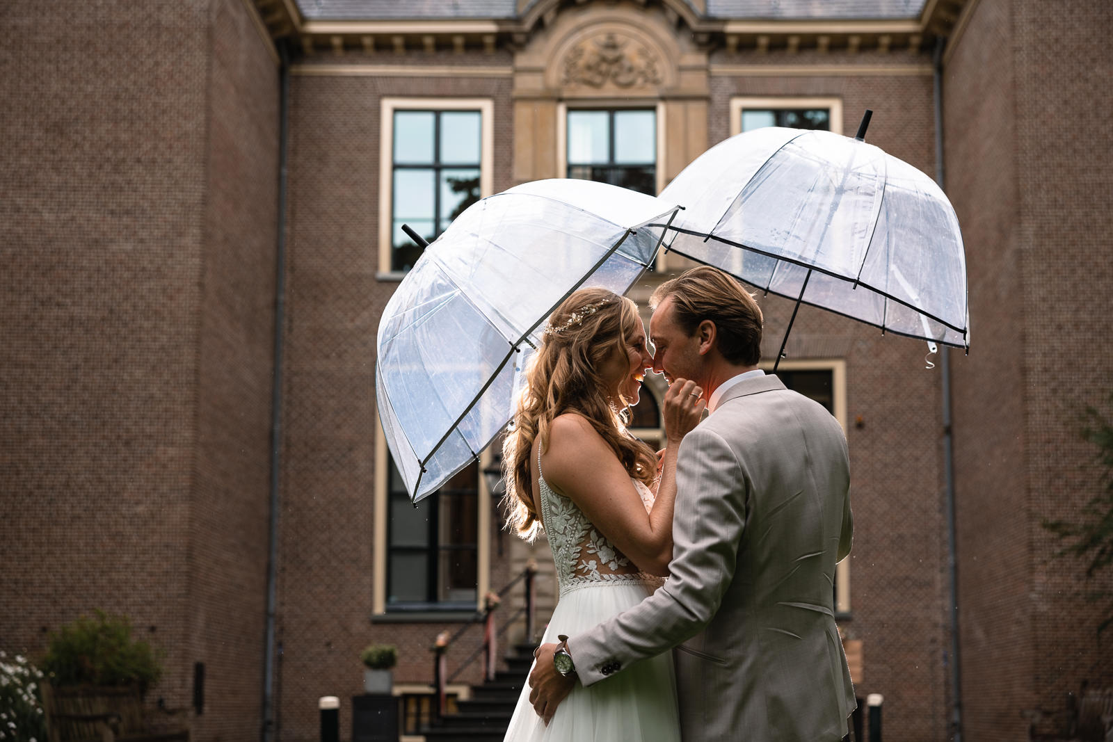 Fotoshoot bruidspaar onder paraplu's bij Kasteel Oud Poelgeest 