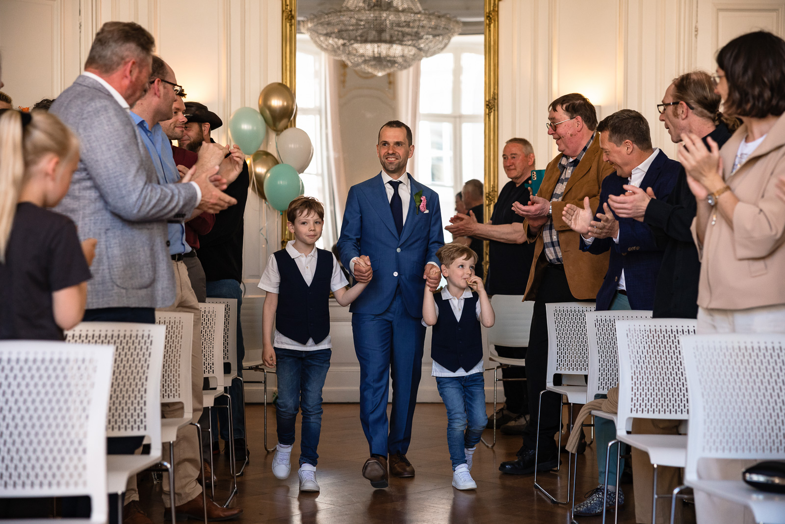 bruidegom loopt op voor ceremonie samen met z'n twee kinderen Trouwfotograaf Spaansche Hof Den Haag