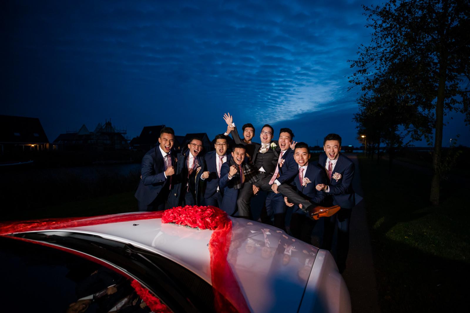 Chinese groomsmen voor de limousine bij bruids ophalen