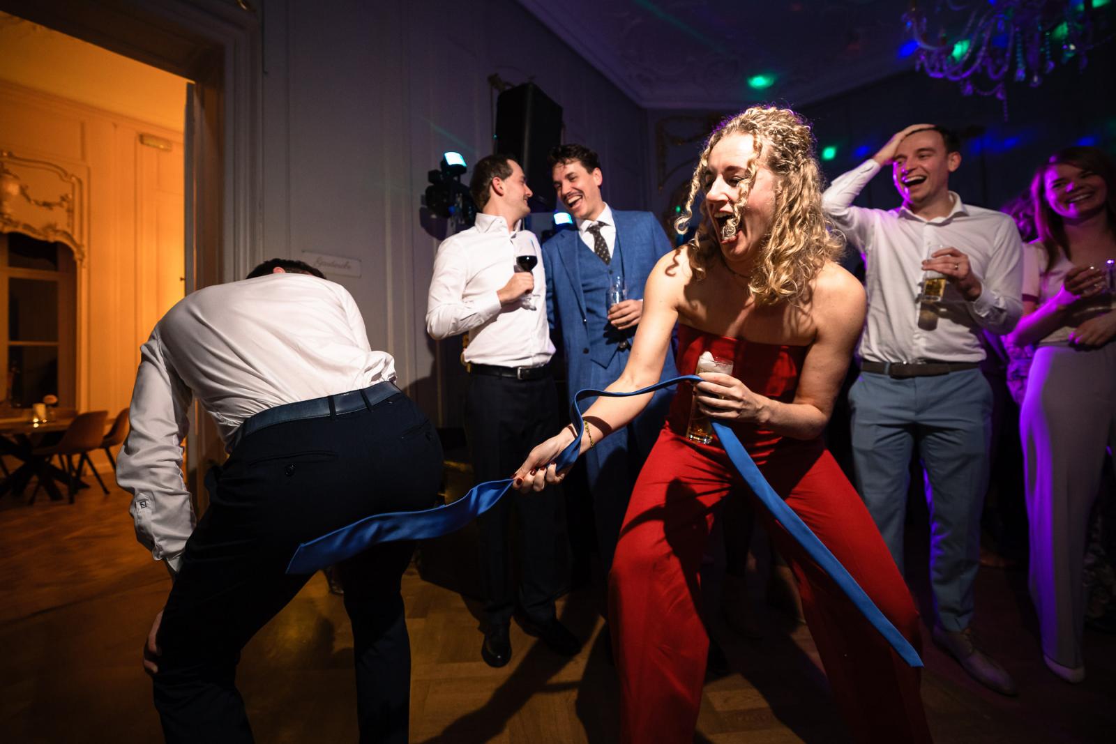Gasten lachen en dansen uitbundig op de dansvloer – feest bruiloft Spaansche Hof Den Haag.