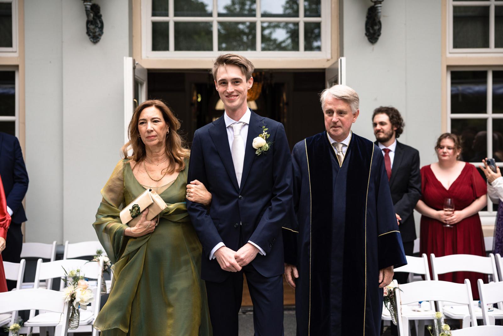 Bruidegom maakt opkomst voor de ceremonie met zijn ouders bij Central Park Voorburg