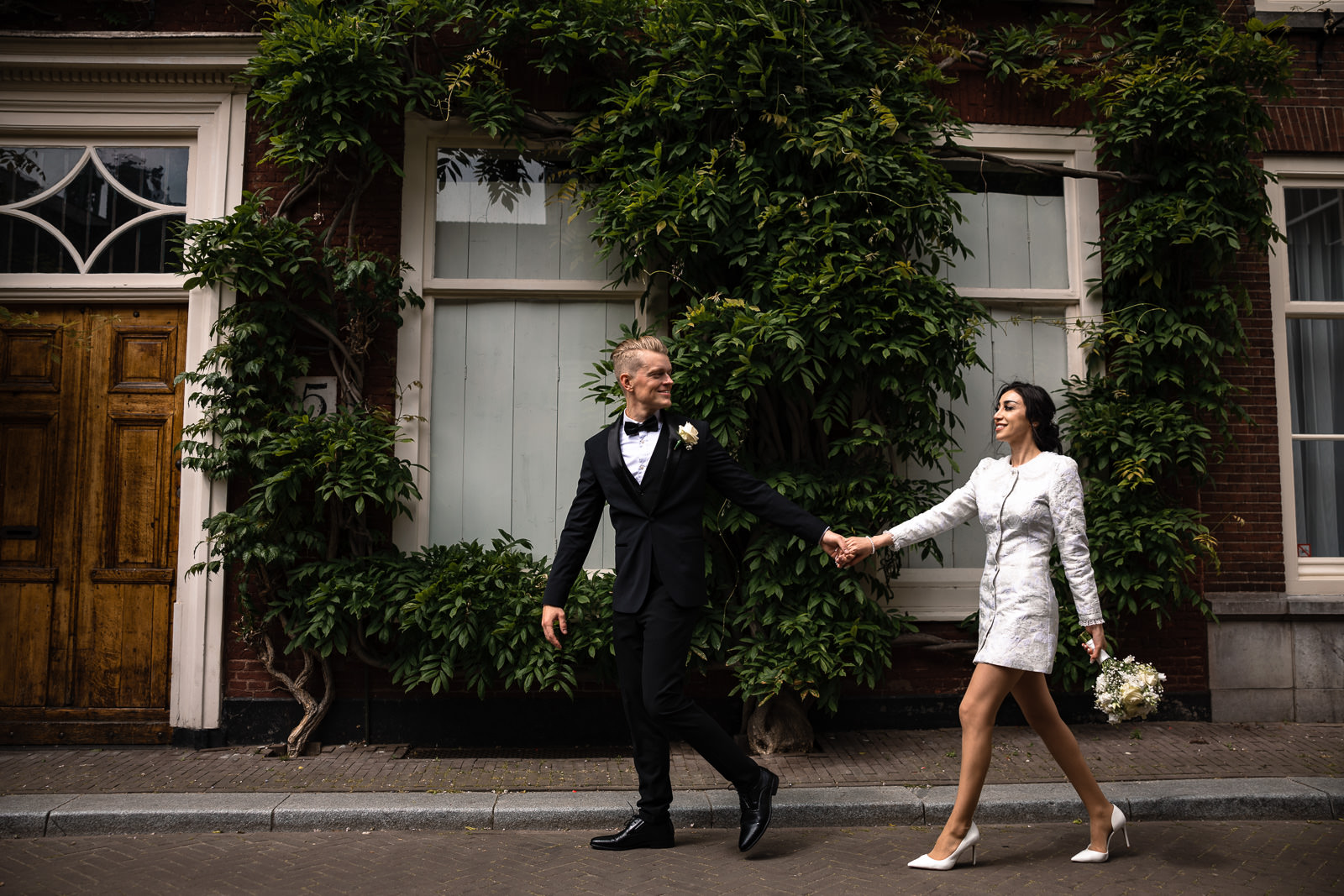 Bride and groom walking through the streets Wedding photographer The Hague 