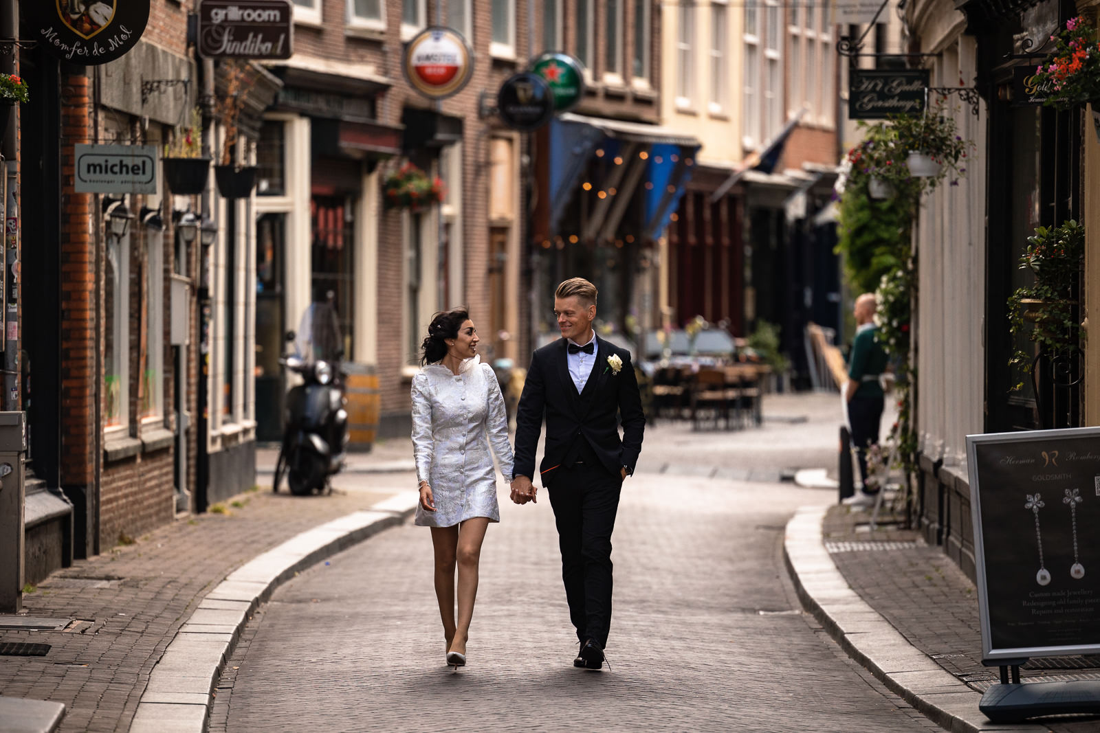 Bride and groom walking through Oude Mol straat Wedding photographer The Hague 