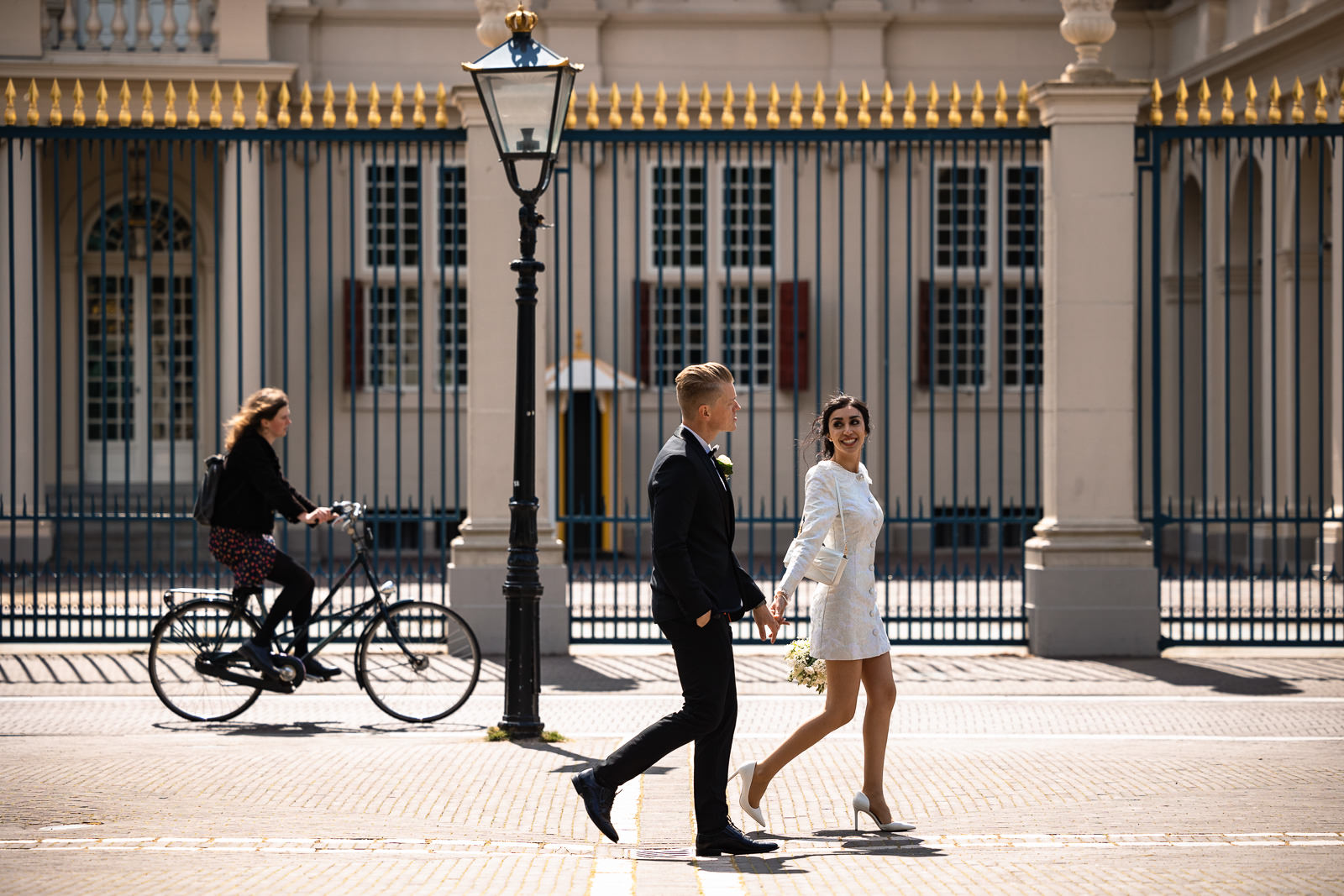 Bride and Groom walking by Paleis Noordeinde Wedding photographer The Hague 