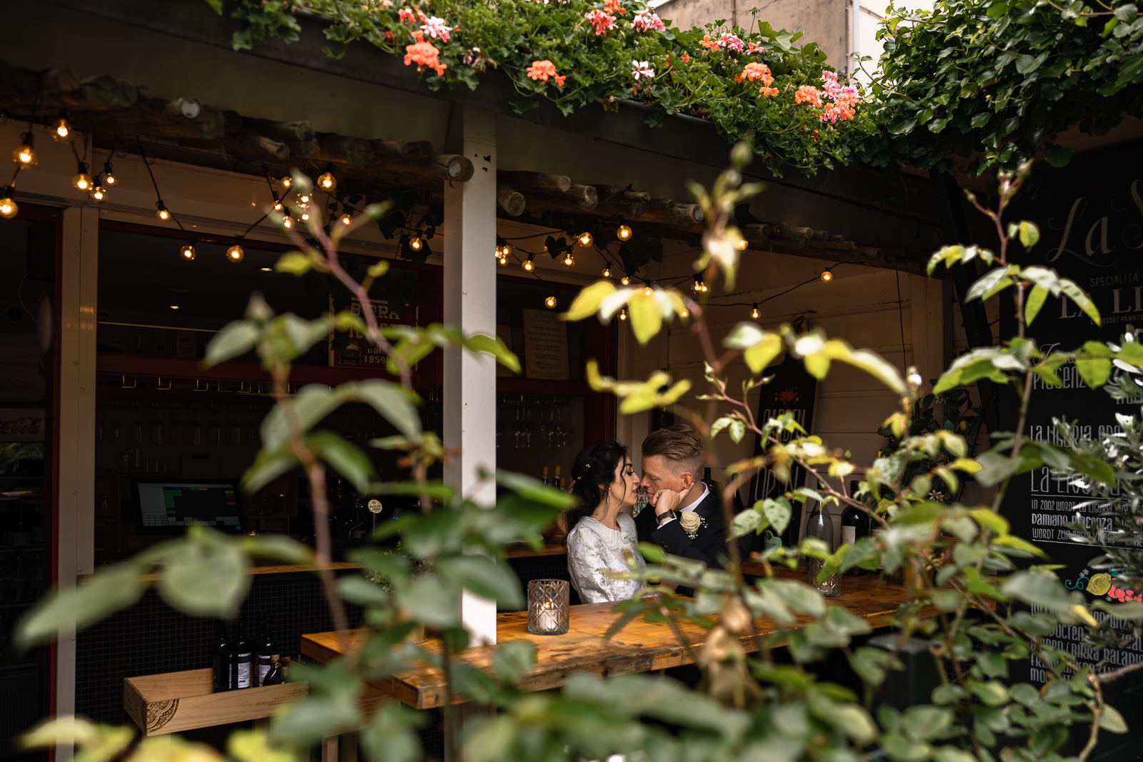 Wedding couple snuggling up in a bar