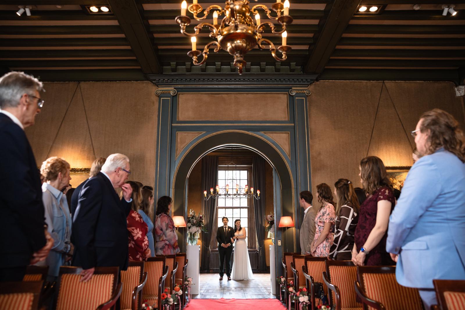 Bruidspaar loopt samen het gangpad op, ceremonie Kasteel de Wittenburg Wassenaar