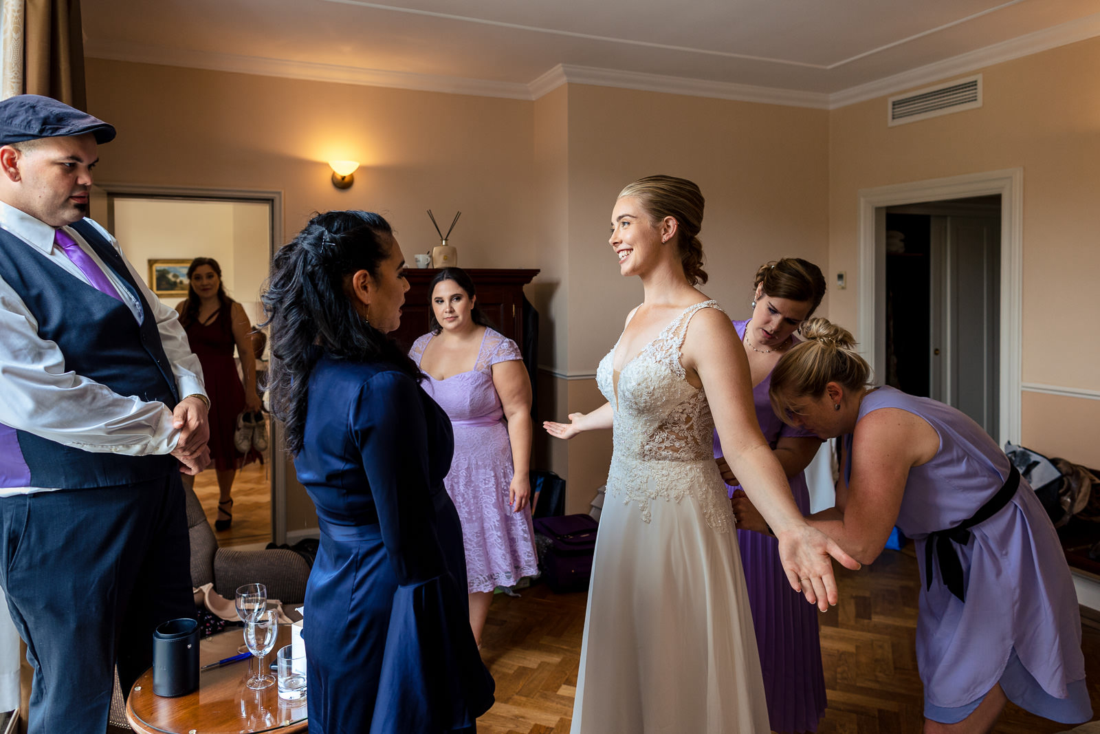 Bride getting her wedding dress on by wedding photographer The Hague