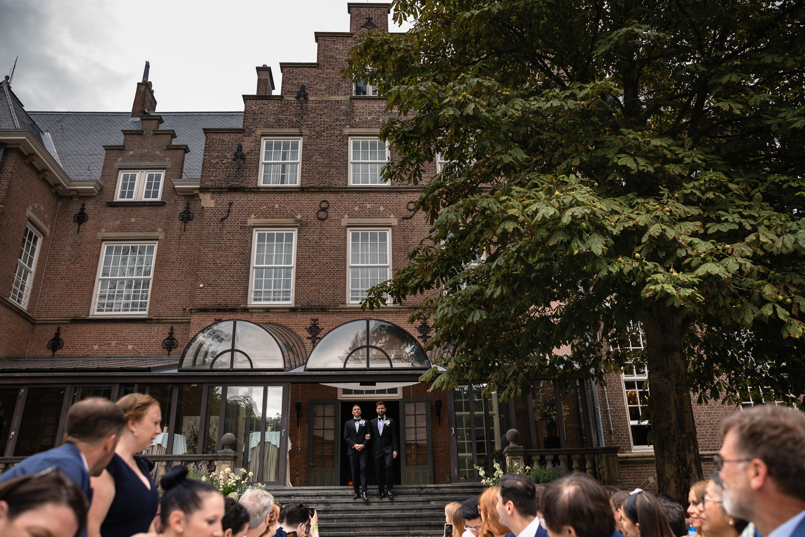 Groom and groom entrance same sex castle wedding