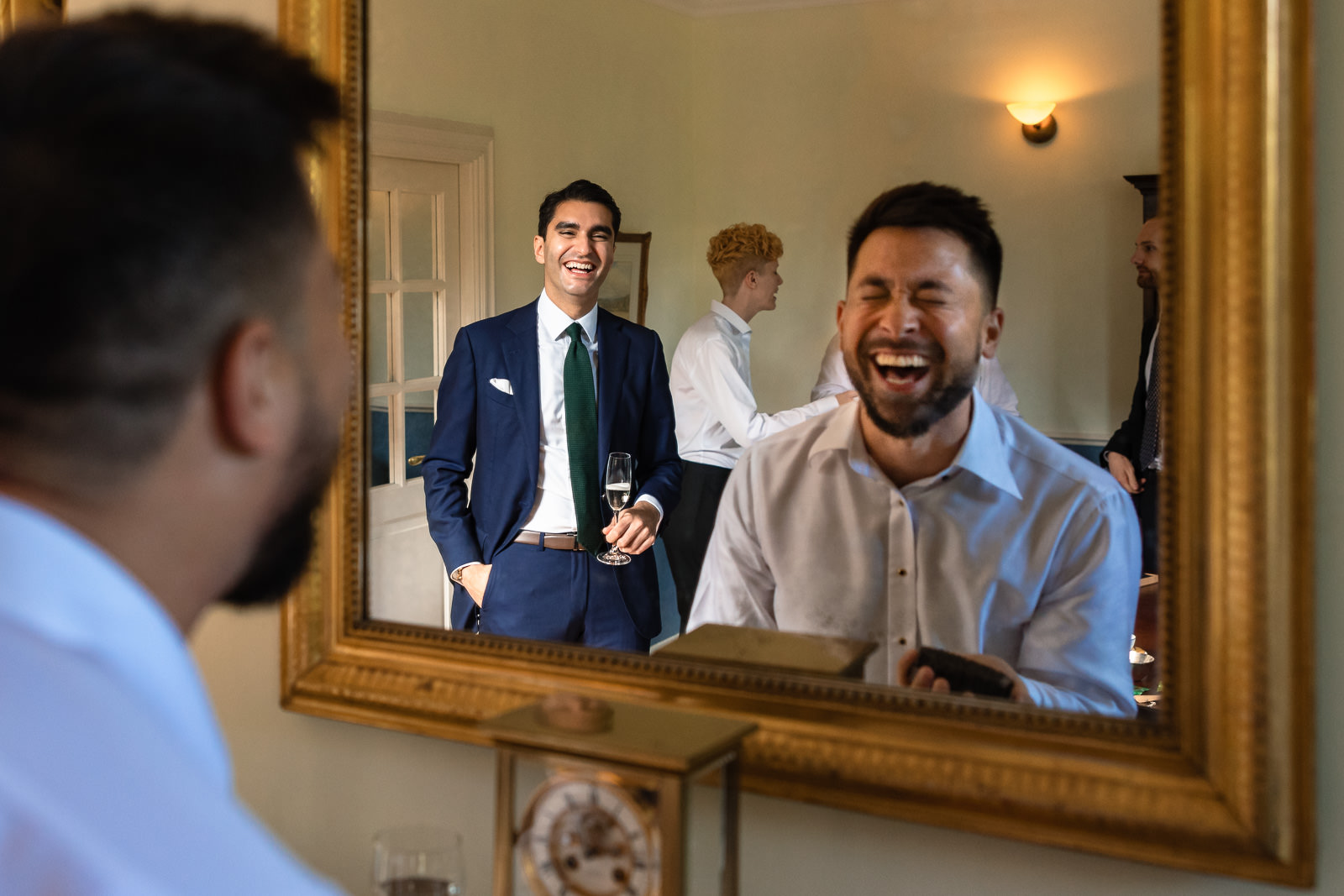 Groom gay wedding getting ready laughing in mirror