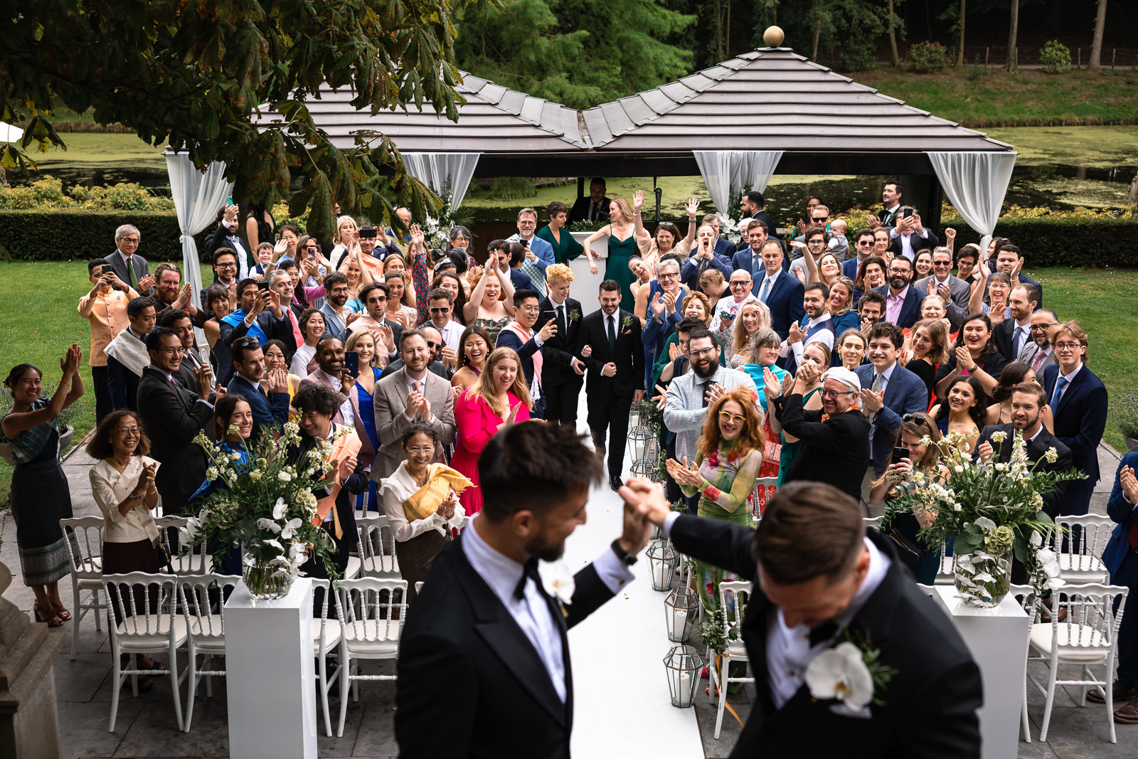 Grooms walking back down the isle after the same sex wedding ceremony