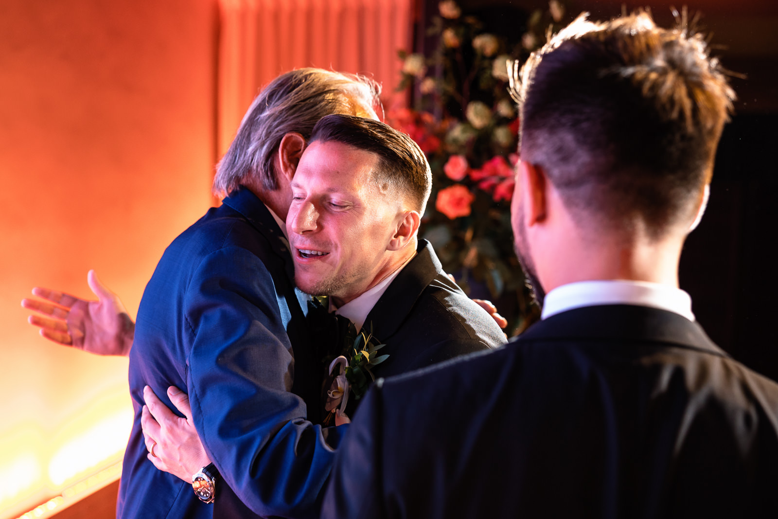 Groom hugs grandfather same sex wedding