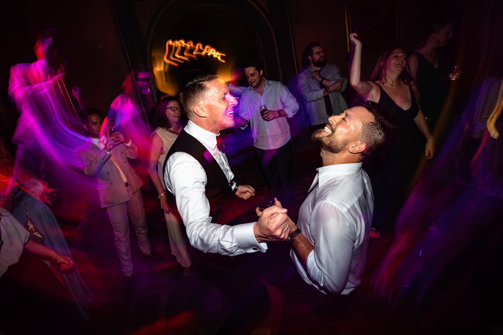 Two grooms partying hard during the same sex wedding in a castle