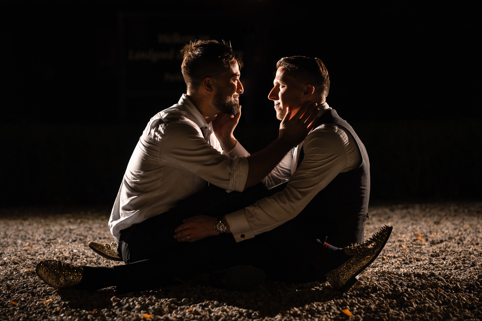 Two grooms during a creative night time shoot to finish of the same sex wedding day