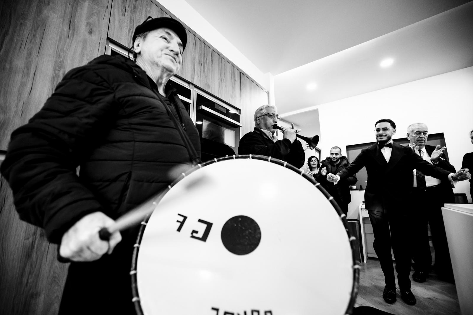 Traditional musicians playing drum and wind instrument at the groom’s house