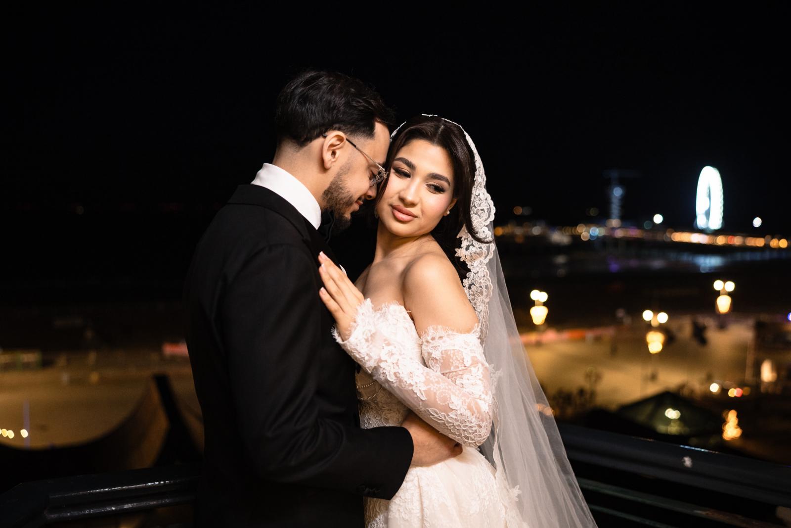 Bride and groom in an intimate evening portrait, Scheveningen Ferris wheel in the distance